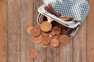 close up of euro coins and wallet on table
