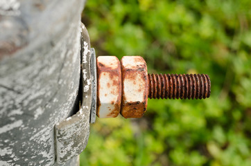 Big rusty metal nuts locked with rust and corrosion bolts