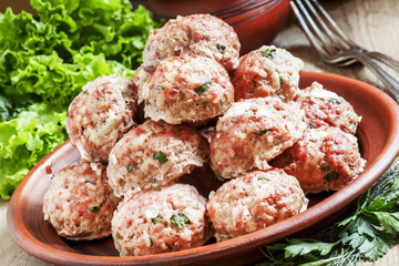 Delicious meat cutlets with herbs on a clay dish in rustic style
