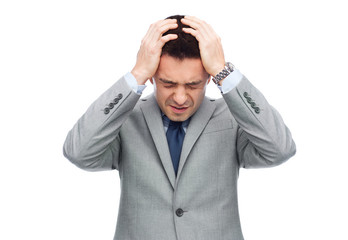 businessman in suit having head ache