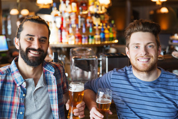 happy male friends drinking beer at bar or pub