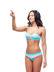 happy woman in bikini swimsuit pointing finger