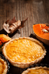 Pumpkin pie on a rustic wooden table