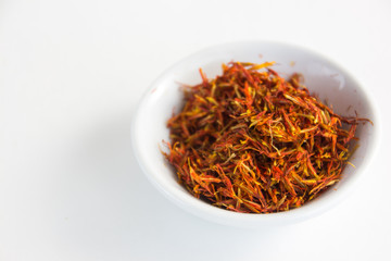 Fototapeta premium saffron in a white bowl on a white background 