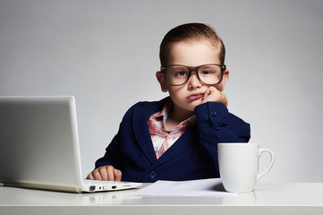 Boring job.Young business boy.funny child in glasses in office