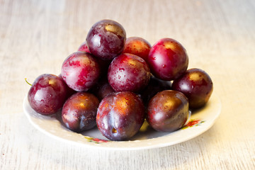 Ripe plums and cherry-plum on a table