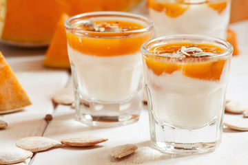 Pumpkin dessert with homemade yogurt and pumpkin seeds in a smal