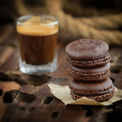 Three chocolate macaroons and a cup of coffee