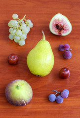 Fresh fruits on wooden background closeup