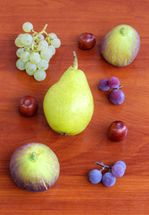 Fresh fruits on wooden background closeup