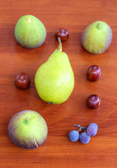 Fresh fruits on wooden background closeup