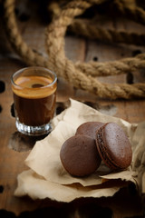 Three chocolate macaroons and a cup of coffee