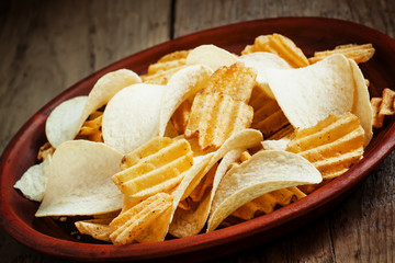 Different potato chips on a plate, beer snack, selective focus