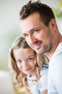Father and daughter looking at camera, portrait