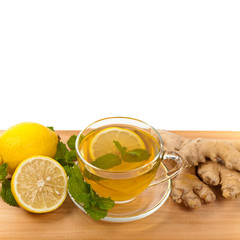 Ginger tea. Ginger, lemon, mint leaves on white background. Selective focus.