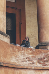 Man taking pictures of architecture at San Luca in Bologna, Ital