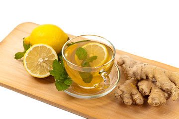 Ginger tea. Ginger, lemon, mint leaves on white background. Selective focus.