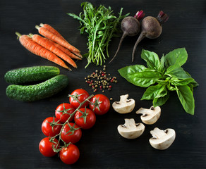 Vegetables on a black wooden background