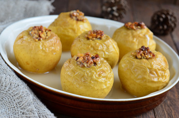 Baked and stuffed apples on wooden boards 