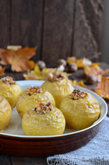 Baked apples on autumnal background 
