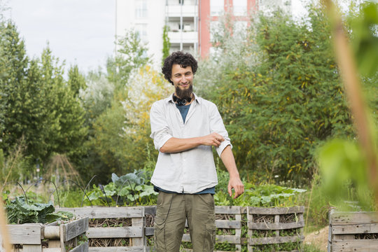 Young man standing in an urban garden