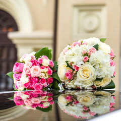 two wedding bouquet of roses on a mirror surface