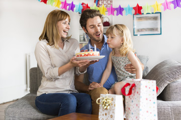 Little girl celebrating birthday party in modern white house. Sh