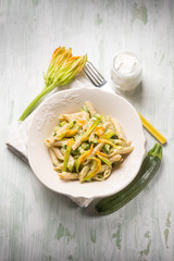 pasta with zucchinis flowers and cream sauce or yogurt