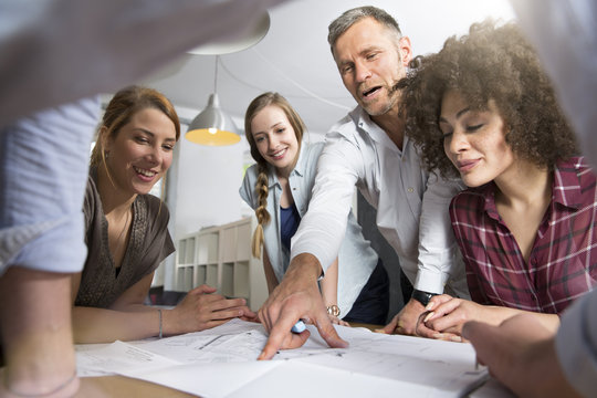Colleagues in office discussing construction plan