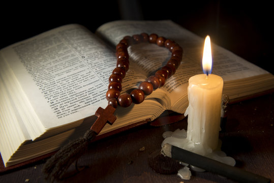 holy book and cross on a wooden background
