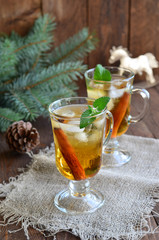 Whiskey cocktail with cinnamon on Christmas background 