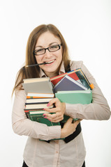 The teacher holds a pile of textbooks and notebooks