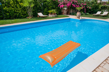 Swimming pool in a flower garden with mattresses
- 93215555