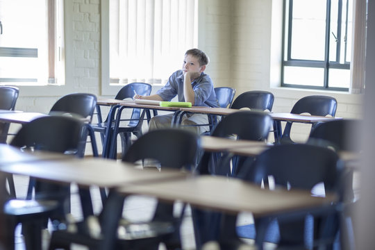 Schoolboy alone in classroom