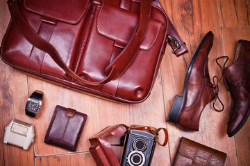 Still life with casual man, boots and bag on wooden  background