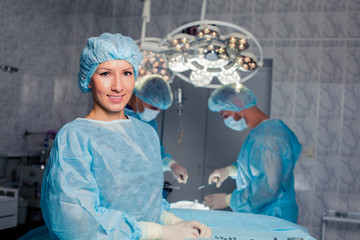 Team surgeon at work in operating room. breast augmentation.