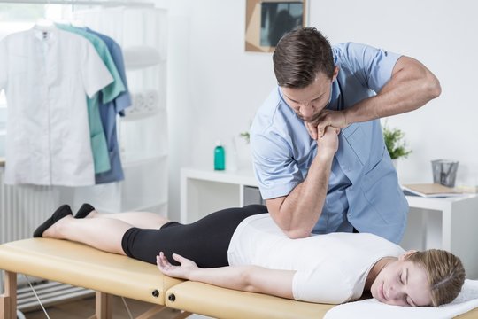 Physiotherapist massaging womans back