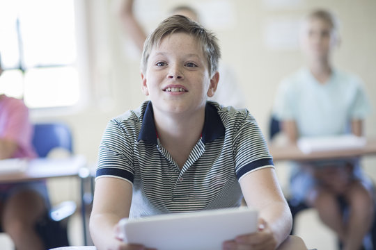 Smiling schoolboy in classroom