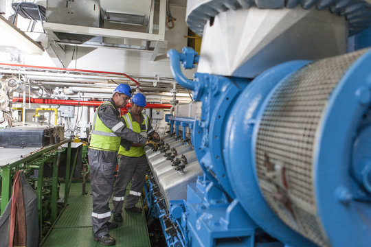 Crew working in engine room on a ship