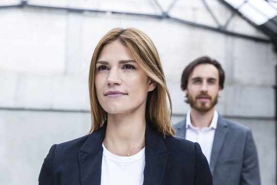 Portrait of businesswoman with her partner in the background