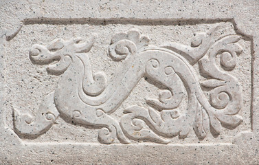 Dragon-shaped stones that adorn the walls of the walk way in a Chinese temple.