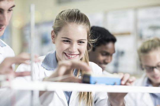 Smiling schoolgirl in physics class