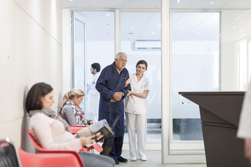 Nurse supporting patient in waiting area