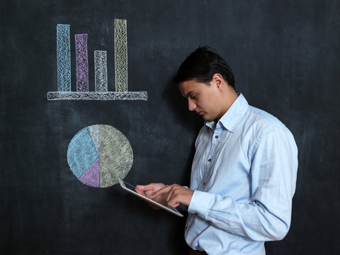 Businessman with tablet checking finacials, male with tablet on