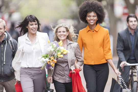 Portrait of three happy women side by side on shopping tour