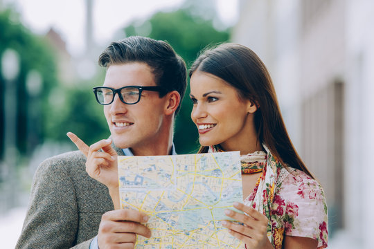Young couple holding map looking for right direction