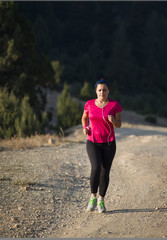 Young woman running on a rural road. Lifestyle sports background.