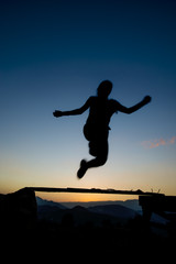 Fototapeta na wymiar jumping over obstacles at sunset young girl day