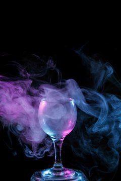 Blue and purple smoke in the glass. Halloween.