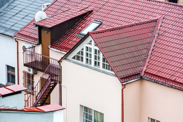 wet tiled red roof with attic windows